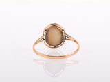 a close up of a gold ring with a brown stone