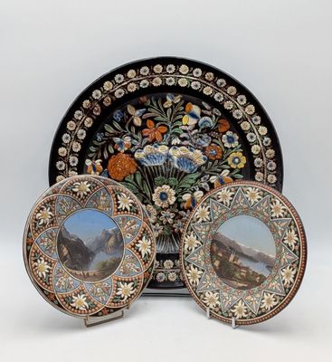 two plates with a picture of a mountain scene on them and a plate with a picture of a mountain scene on it