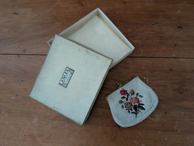 a small purse and a small purse on a wooden table
