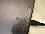 a laptop computer sitting on a table with a charger