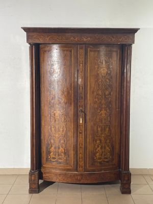 a large wooden cabinet with a door on top of it