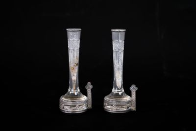 two glass vases that are sitting on a black surface