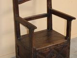 a wooden chair that is sitting in a room