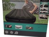 an image of a man sitting on top of an inflatable sleeping bag