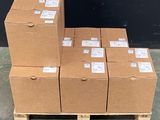 several boxes are stacked on a pallet in front of a black wall