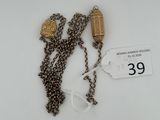 a necklace that has two charms attached to it