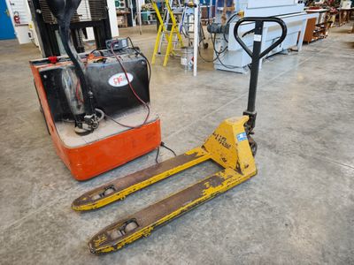 a forklift sitting on the floor in a warehouse
