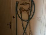 a hose attached to the wall next to a faucet