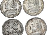 quatre pièces d'argent représentant des visages d'hommes et d'une femme
