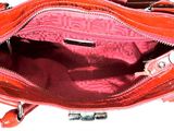 a red purse that is open on a white surface