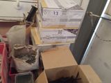 many boxes of assorted items in a cluttered room