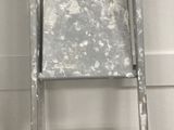 a ladder that is leaning against a wall next to a box