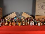 many bottles of alcohol lined up on a table