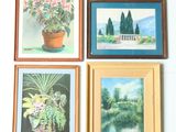 four framed paintings of flowers on a wall in a room