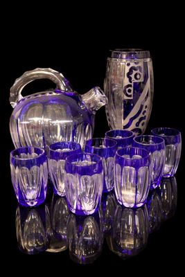 a lot of glasses and a pitcher sitting on a table