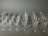 many wine glasses lined up on a table