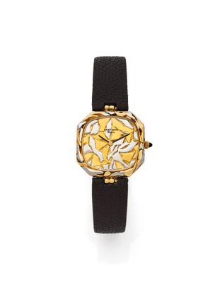 a close up of a watch on a white surface