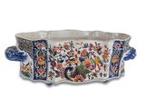 an image of a decorative planter with flowers and birds on it