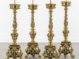 a set of four antique brass candlesticks