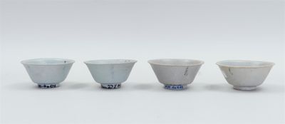 three white and blue bowls sitting next to each other on a white surface