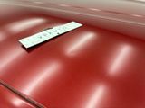a sticker on the hood of a red car