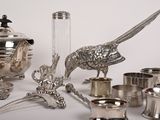 many silver objects that are sitting on a table