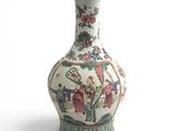 a vase that has a picture of people on it