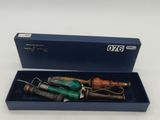 an image of a pen in a blue box on a white surface