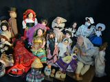 a lot of dolls that are sitting together on a table