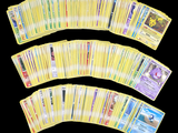 a lot of pokemon cards on a black background