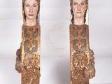 pair of antique carved wood head sculptures of a woman and a man