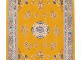 a yellow rug with a floral design on the center