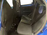 the back seats of a small blue car with a black seat belt