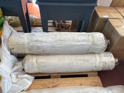 several rolls of paper sitting on top of a pallet next to boxes
