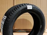 tires are stacked on a cardboard box in front of a corrugated wall