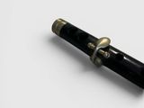 a pen that is laying on a white surface