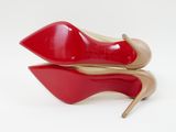red and beige high heeled shoes on a white surface