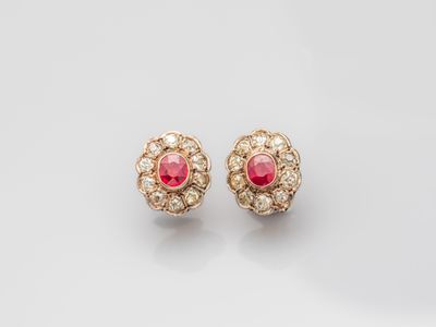 a pair of ruby and diamond earrings