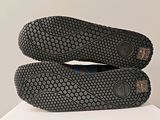 pair of black shoes sitting on top of a white table