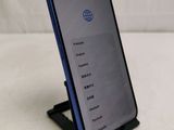 a phone that is sitting on a stand on a table