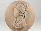 a plaster plaque of a woman with a turban on her head