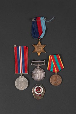 three medals and a medal on a black surface