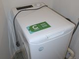 a washing machine in the corner of a small room