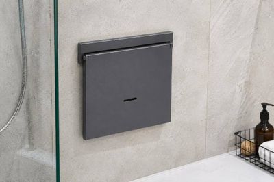 a bathroom with a glass shower door and a soap dispenser