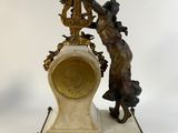 a statue of a man and a woman on a clock