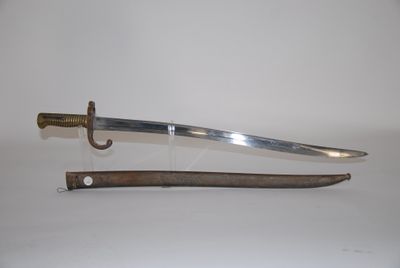 an old sword with a wooden handle on a white surface