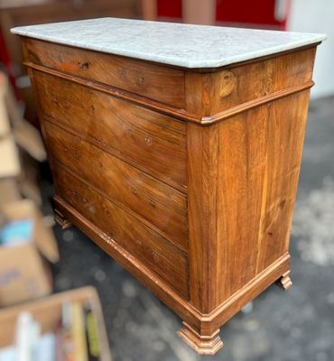 a wooden chest with a marble top in a room