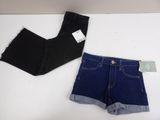 two pairs of black and blue denim shorts on a white table