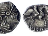 a silver coin with an image of a woman and a man on it