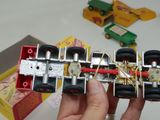 a person holding a model of a car made out of legos